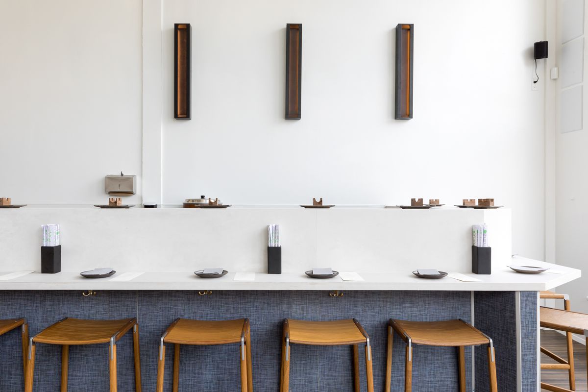 A view of the second bar at Handroll Project, with white walls and a white bartop.