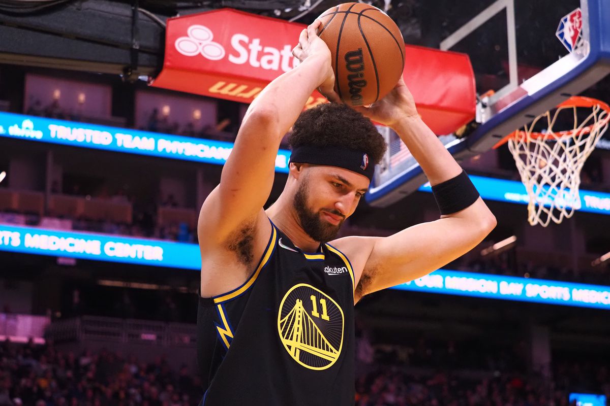 Golden State Warriors guard Klay Thompson (11) holds the ball over his head after a play against the Denver Nuggets during the second quarter at Chase Center. Mandatory Credit: Kelley L Cox