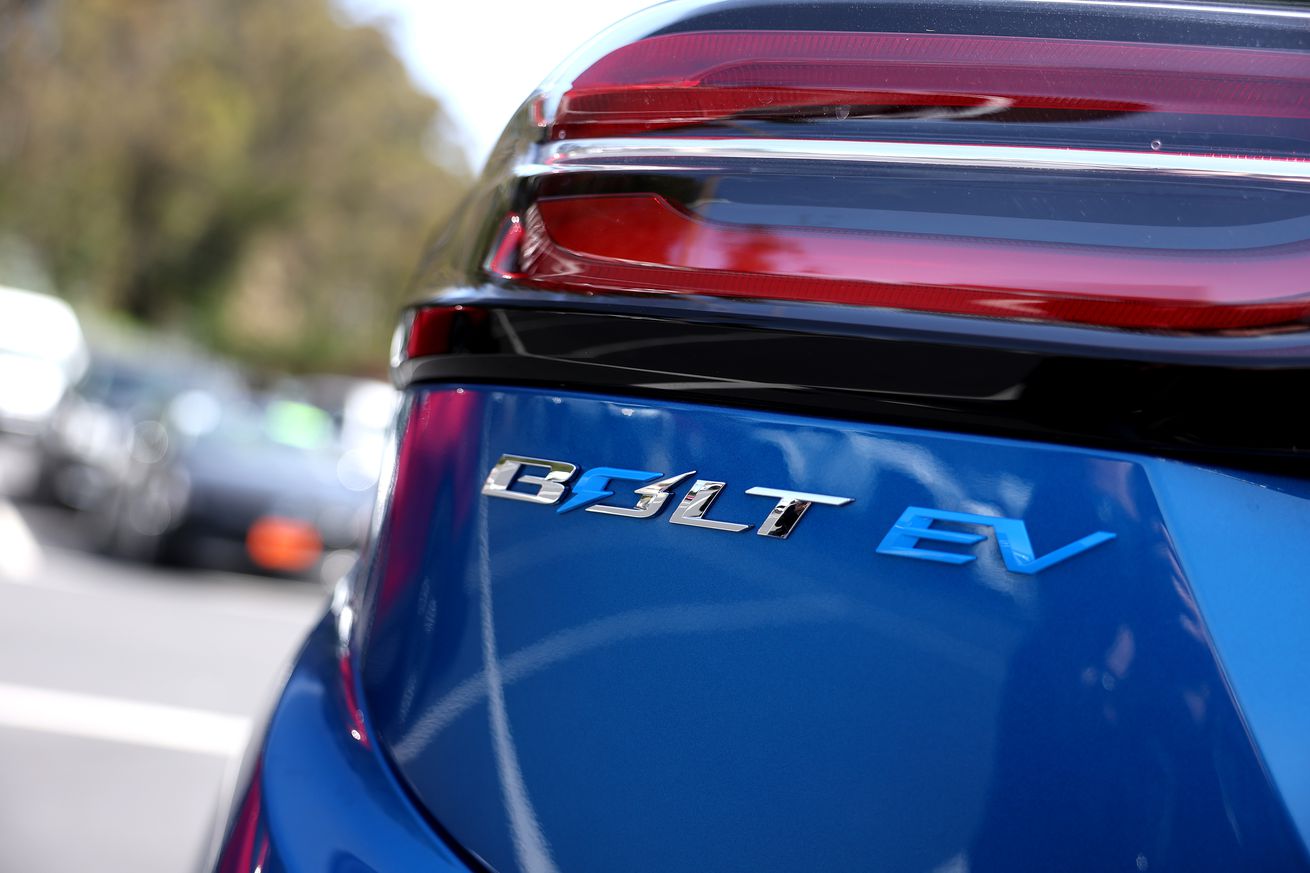 A logo is displayed on a Chevrolet Bolt EV that sits on the sales lot at Stewart Chevrolet on April 25th, 2023