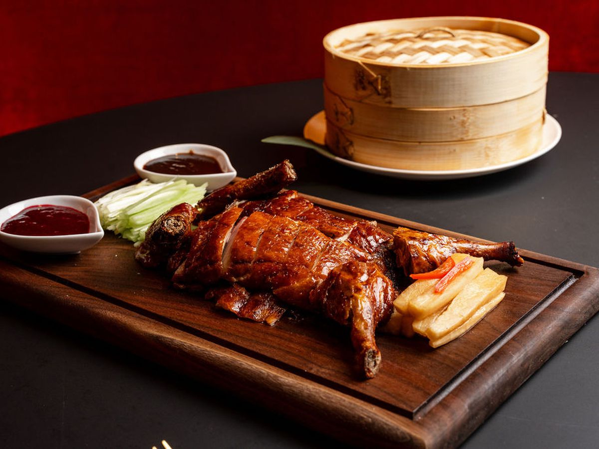A spread of sliced Beijing duck with accoutrement.