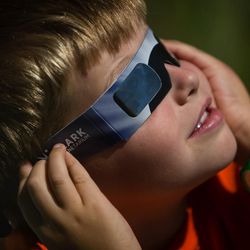 Isaac Williams struggles to keep his glasses on while viewing the eclipse at Park City Mountain in Park City on Monday, Aug. 21, 2017. The partial eclipse was at 90 percent of totality in Park City.