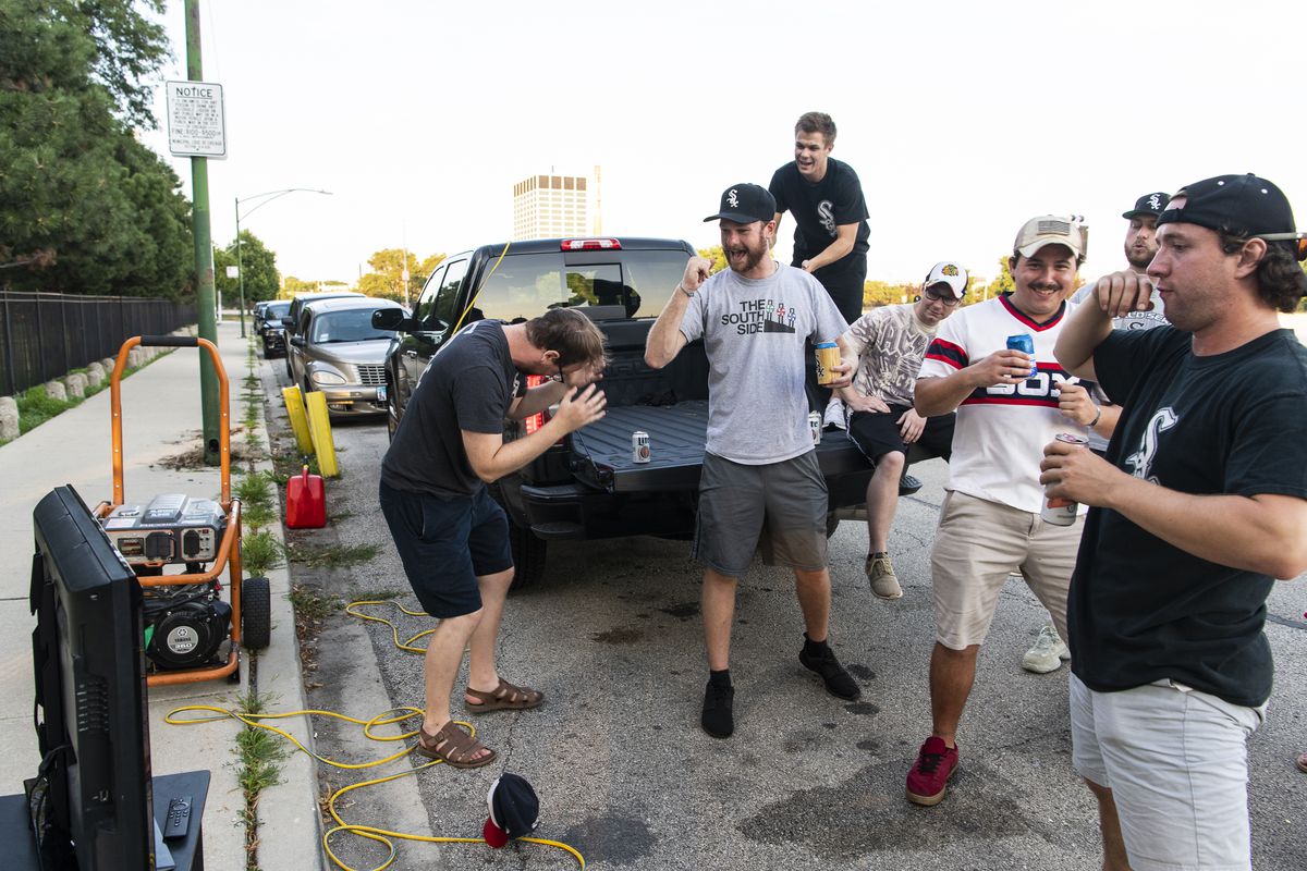 Fans of the Chicago White Sox tailgate outside of Guaranteed Rate Field during the opening day game against the Minnesota Twins, Friday evening, July 24, 2020.