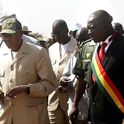 Current Malian president Amadou Toumani Toure, left, walks with candidate Yeah Samake.