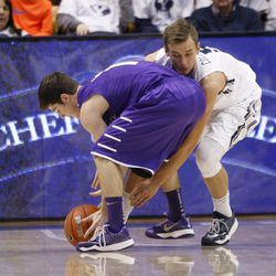 Brigham Young Cougars guard Kyle Collinsworth (5) tries to steal the ball from Bobby Sharp as Brigham Young University plays Portland in NCAA men's basketball Monday, Dec. 29, 2014, in Provo.  
