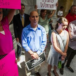 Tony Escobar and Tina Escobar-Taft, who stand in support of Planned Parenthood, Mike Cuollo, who opposes Planned Parenthood, and Rachel Adams and Max Eyres, also supporting Planned Parenthood, listen during a rally to encourage the defunding of Planned Parenthood at the state Capitol in Salt Lake City on Wednesday, Aug. 19, 2015.
 (Submission date: 08/19/2015)