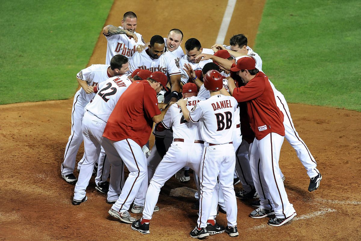 PHOENIX - JUNE 16:  The Arizona Diamondbacks celebrate a walk off victory against the San Francisco Giants at Chase Field on June 16, 2011 in Phoenix, Arizona.  (Photo by Norm Hall/Getty Images)