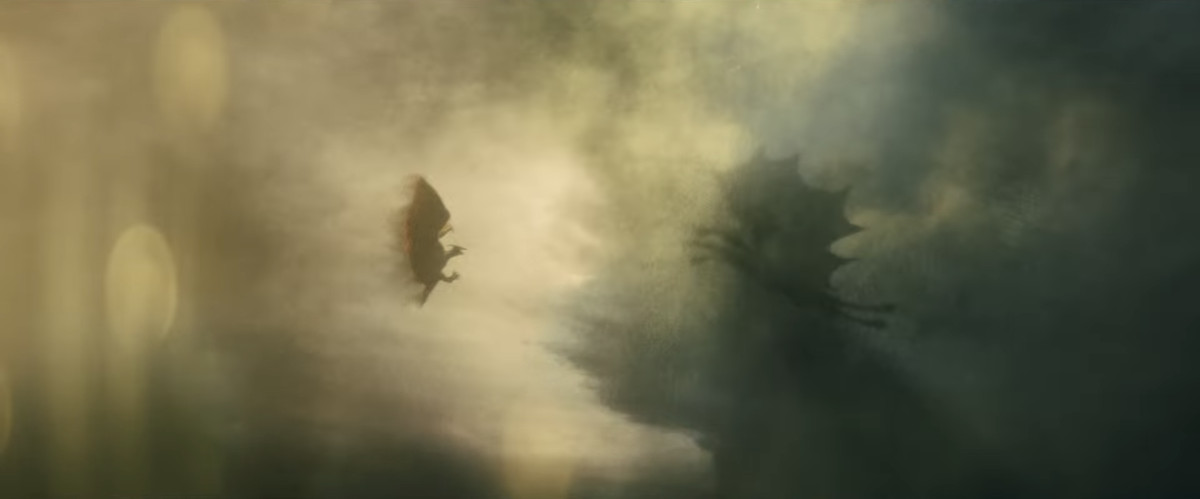Rodan and Ghidorah flying to each other in the pouring rain.