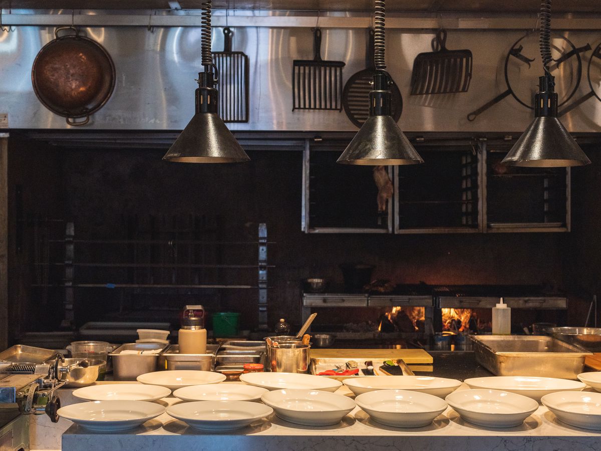 An open kitchen with plates lined up ready for service.