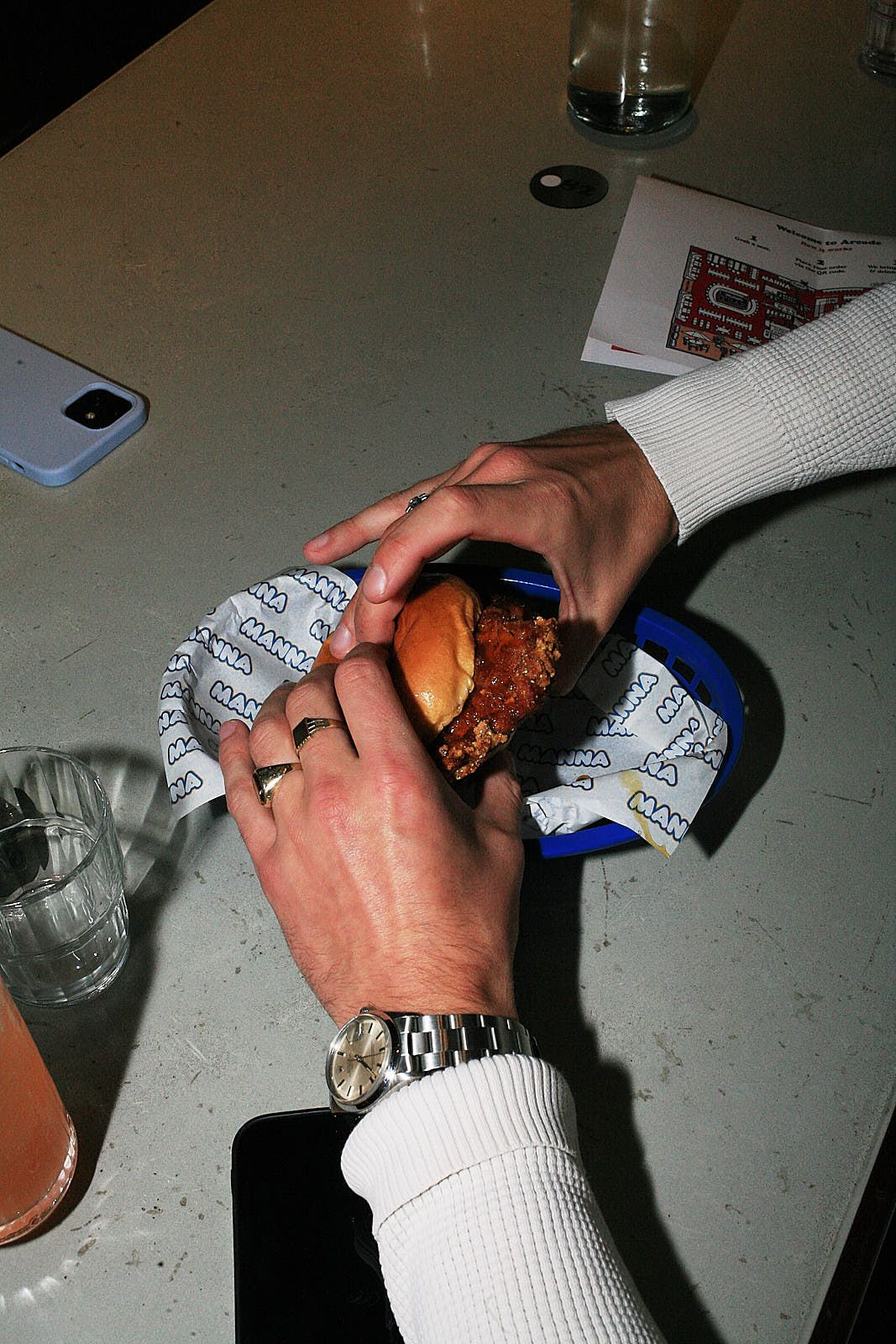 A Nashville hot chicken burger in a diner-style blue basket