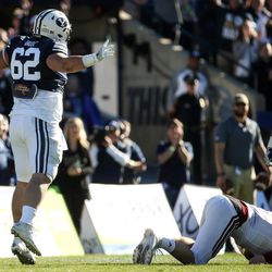 Brigham Young Cougars defensive lineman Logan Taele (62) reacts after sacking UMass Minutemen quarterback Andrew Ford (7) during a game at LaVell Edwards Stadium in Provo on Saturday, Nov. 19, 2016.