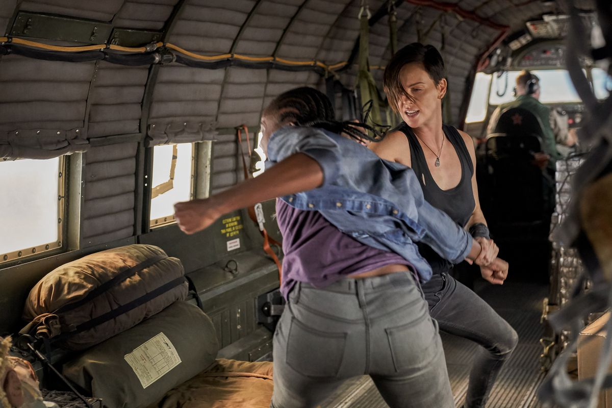 Charlize Theron and KiKi Layne punch the crap out of each other in a plane in The Old Guard.