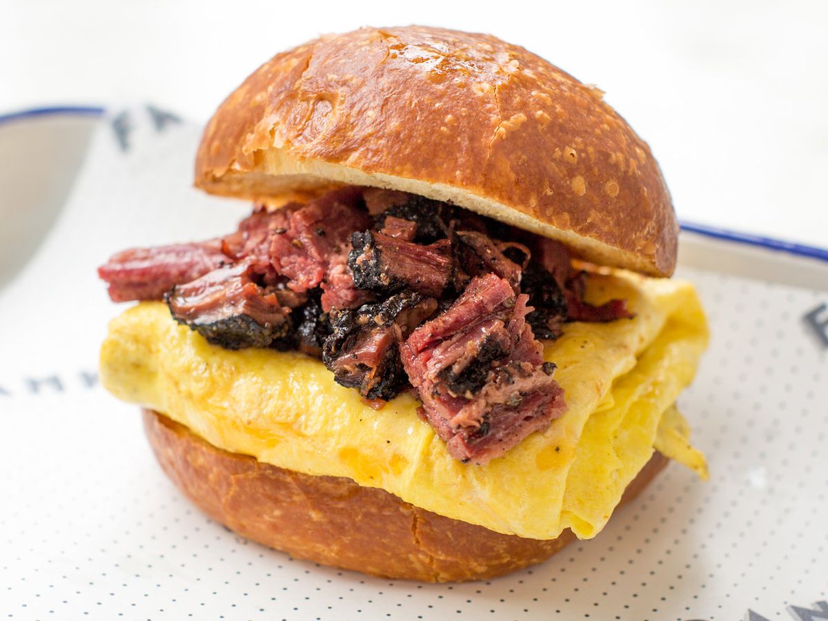 A pastrami and egg sandwich