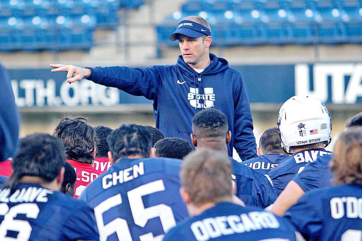 Utah State head football coach Matt Wells addresses his team at the end of its first spring practice Wednesday morning at Maverik Stadium in Logan.