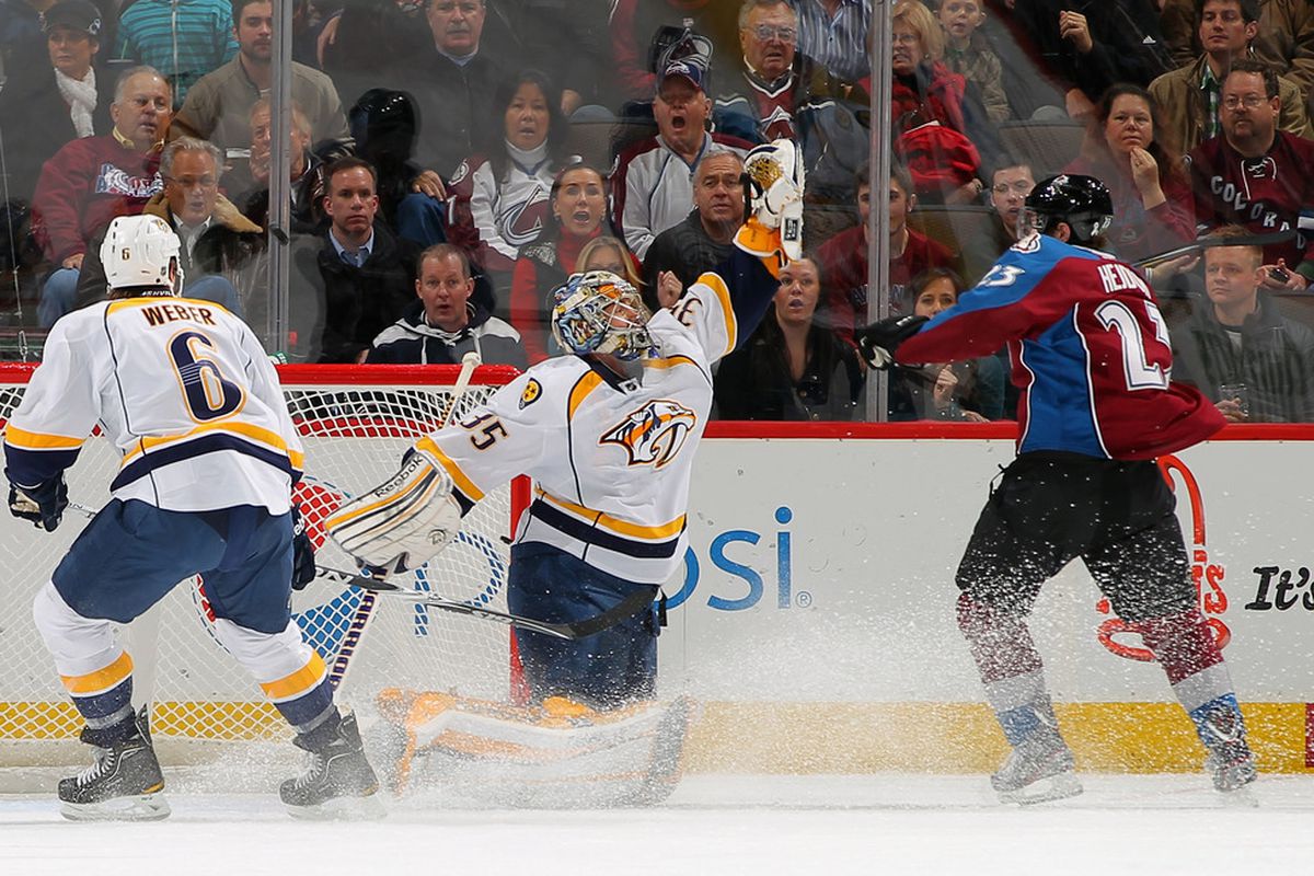 DENVER, CO - JANUARY 10:  Goalie Pekka Rinne #35 of the Nashville Predators collects the puck against Milan Hejduk #23 of the Colorado Avalanche at the Pepsi Center on January 10, 2012 in Denver, Colorado.  (Photo by Doug Pensinger/Getty Images)
