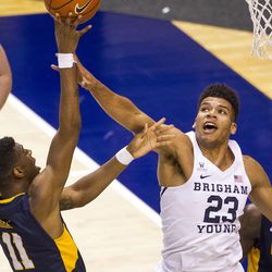 Coppin State forward Izais Hicks (11) gets a shot off over Brigham Young forward Yoeli Childs (23) during an NCAA college basketball game in Provo on Thursday, Nov. 17, 2016.