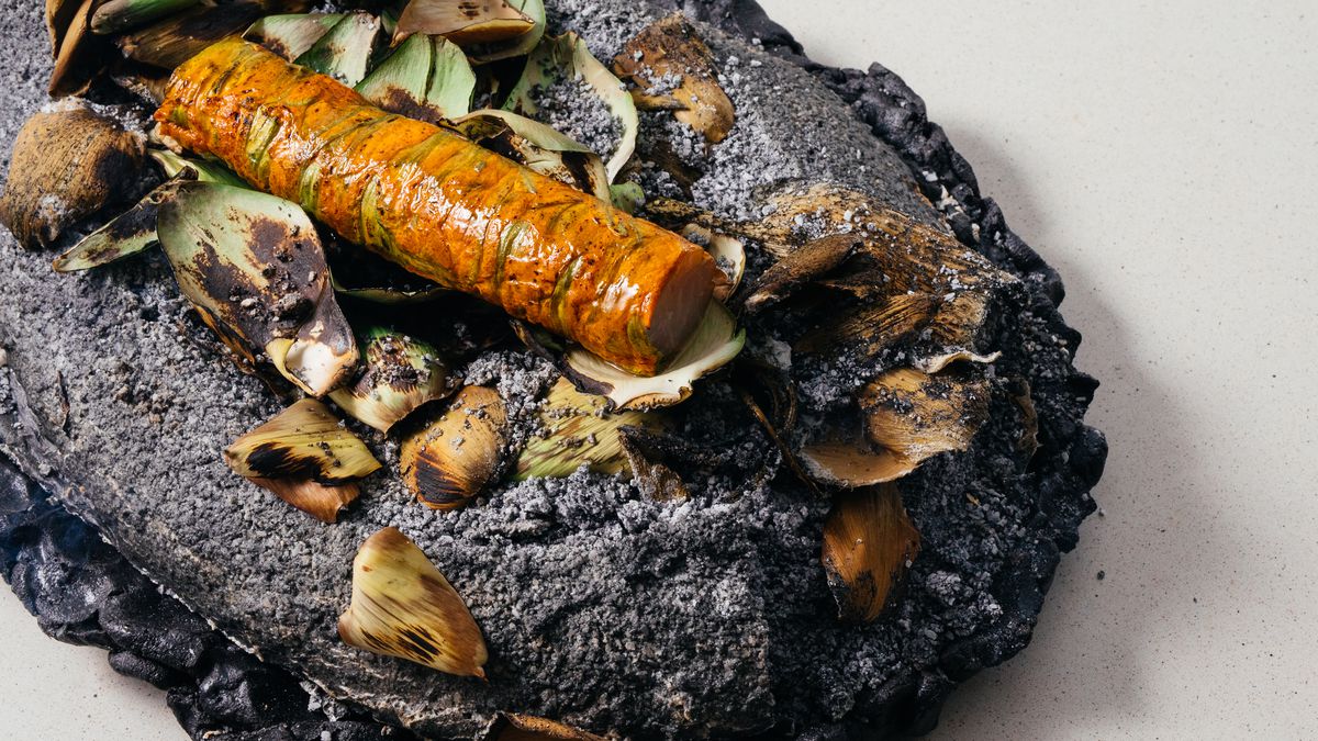 Sable fish wrapped in squash blossoms and salt baked. The salt bake is seasoned with roasted artichoke leaves.