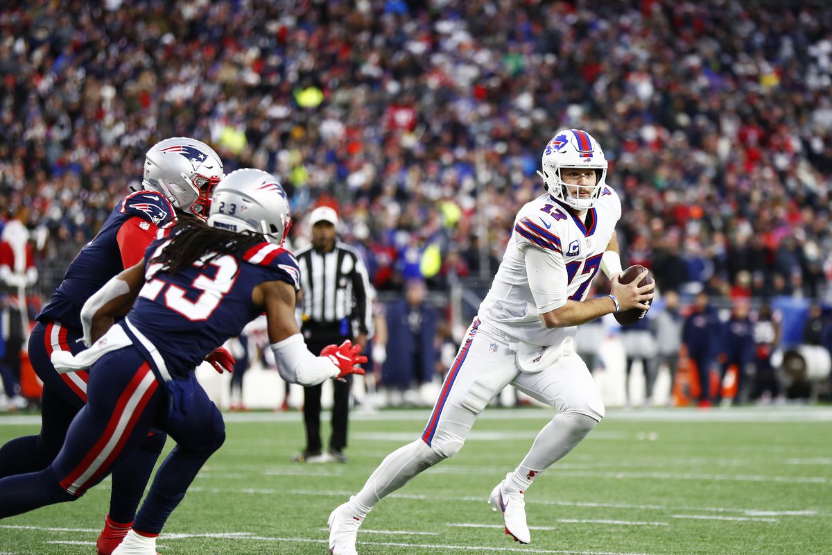 Quarterback Josh Allen #17 of the Buffalo Bills rolls out to his left during the fourth quarter of the game against the New England Patriots at Gillette Stadium on December 26, 2021 in Foxborough, Massachusetts.
