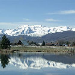 The back of Mount Timpanogos is reflected in a pond at the Johnson Mill property in Midway. 