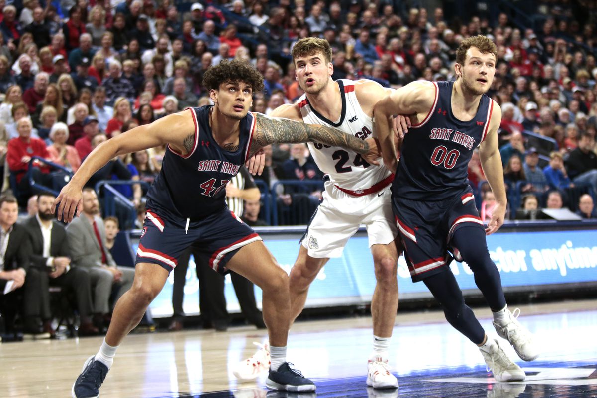 Dan Fotu and Tanner Krebs of the Saint Mary’s Gaels box out Corey Kispert of the Gonzaga Bulldogs after a free throw in the second half at McCarthey Athletic Center on February 29, 2020 in Spokane, Washington. Gonzaga defeats Saint Mary’s 86-76.