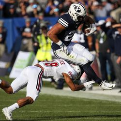 Brigham Young Cougars defensive back KJ Hall (20) is tackled by UMass Minutemen cornerback Jackson Porter (28) during a game at LaVell Edwards Stadium in Provo on Saturday, Nov. 19, 2016.