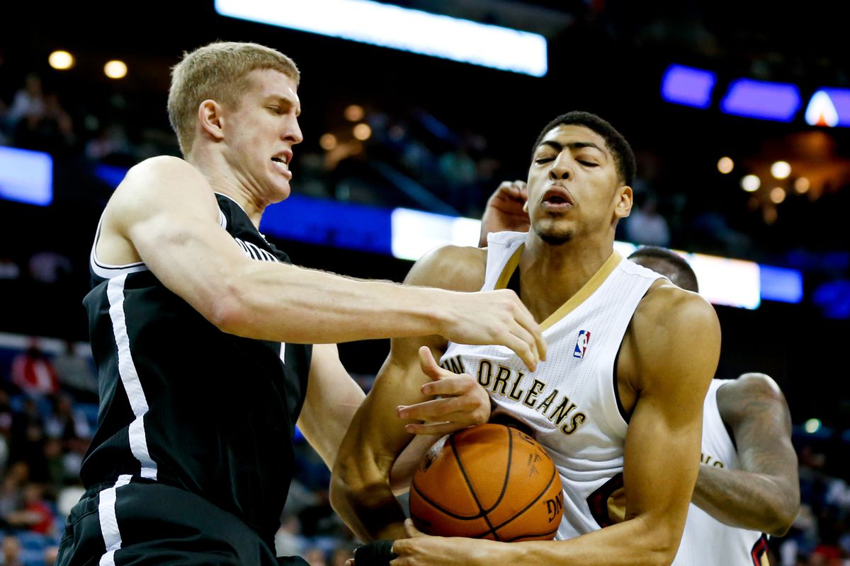 Mar 24, 2014; New Orleans, LA, USA; New Orleans Pelicans forward Anthony Davis (23) and Brooklyn Nets forward Mason Plumlee (1) battle for possession of the ball during overtime of a game at the Smoothie King Center. 
