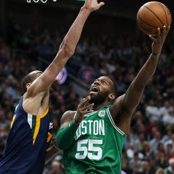 Boston Celtics center Greg Monroe (55) goes to the hoop against Utah Jazz center Rudy Gobert (27) at Vivint Smart Home Arena in Salt Lake City on Wednesday, March 28, 2018.