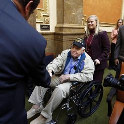 Smitty Smith is greeted as veterans are honored in the House of Representatives in Salt Lake City, Wednesday, Feb. 18, 2015. He is helped by Sheryl Worsley, news director for KSL Radio.
