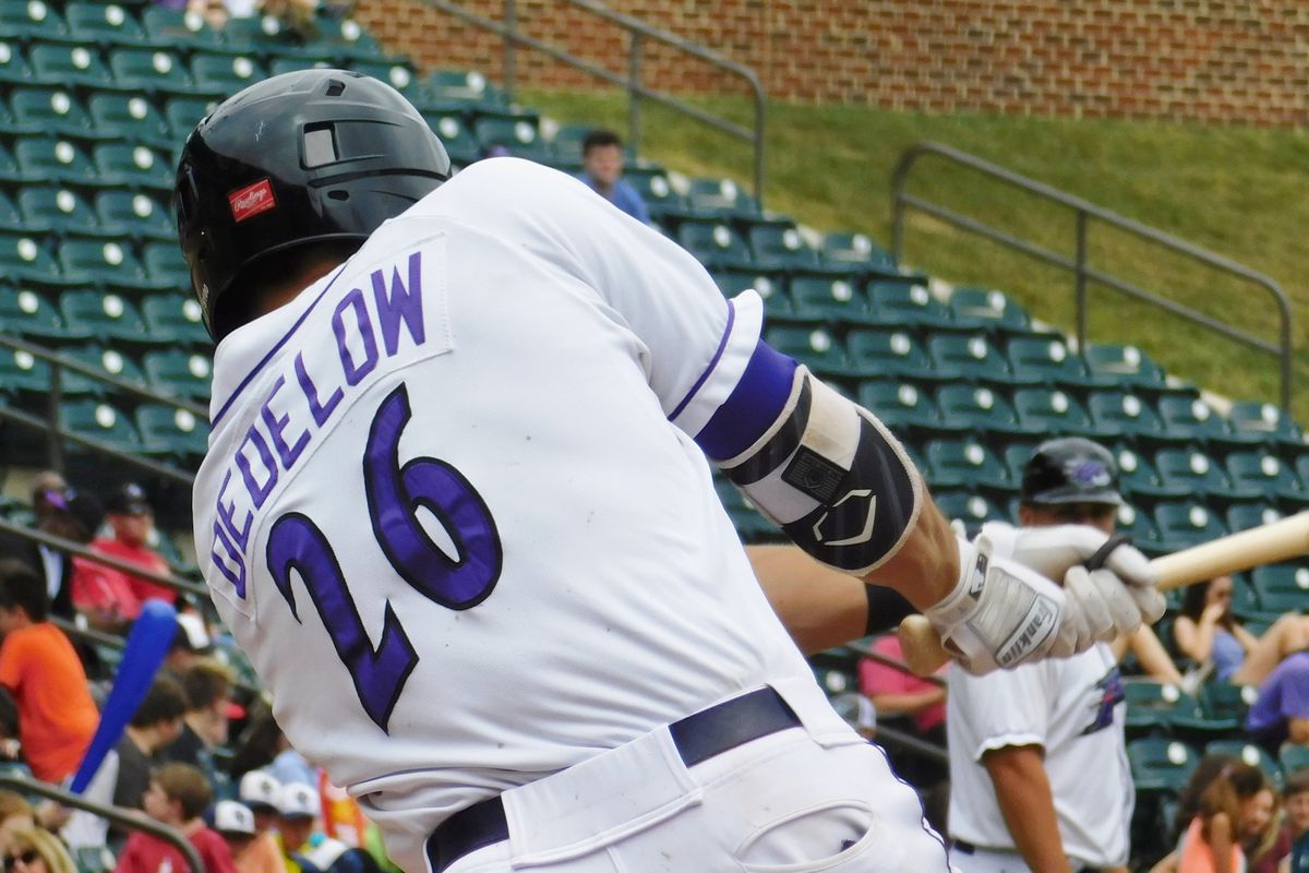 Craig Dedelow #26 bats from behind, mid-swing