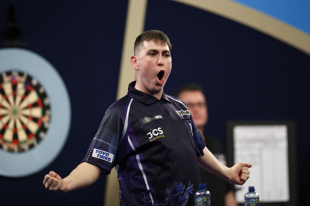 William Borland of Scotland reacts to a nine dart finish during his First Round match against Bradley Brooks of England during the William Hill World Darts Championship at Alexandra Palace on December 17, 2021 in London, England.