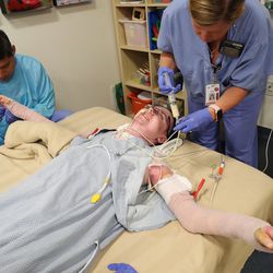 Burn victim Austin Weaver receives pain medication from registered nurse Mindy Orr during physical therapy with occupational therapist Xavier Lucio at University of Utah Health's Burn Center in Salt Lake City on Friday, July 20, 2018. Weaver's family says his life has essentially been saved by a new burn treatment substance called SkinTE.