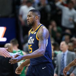 Utah Jazz forward Joe Ingles (2), forward Derrick Favors (15) and guard Donovan Mitchell (45) celebrate a point over the Boston Celtics at Vivint Smart Home Arena in Salt Lake City on Wednesday, March 28, 2018.