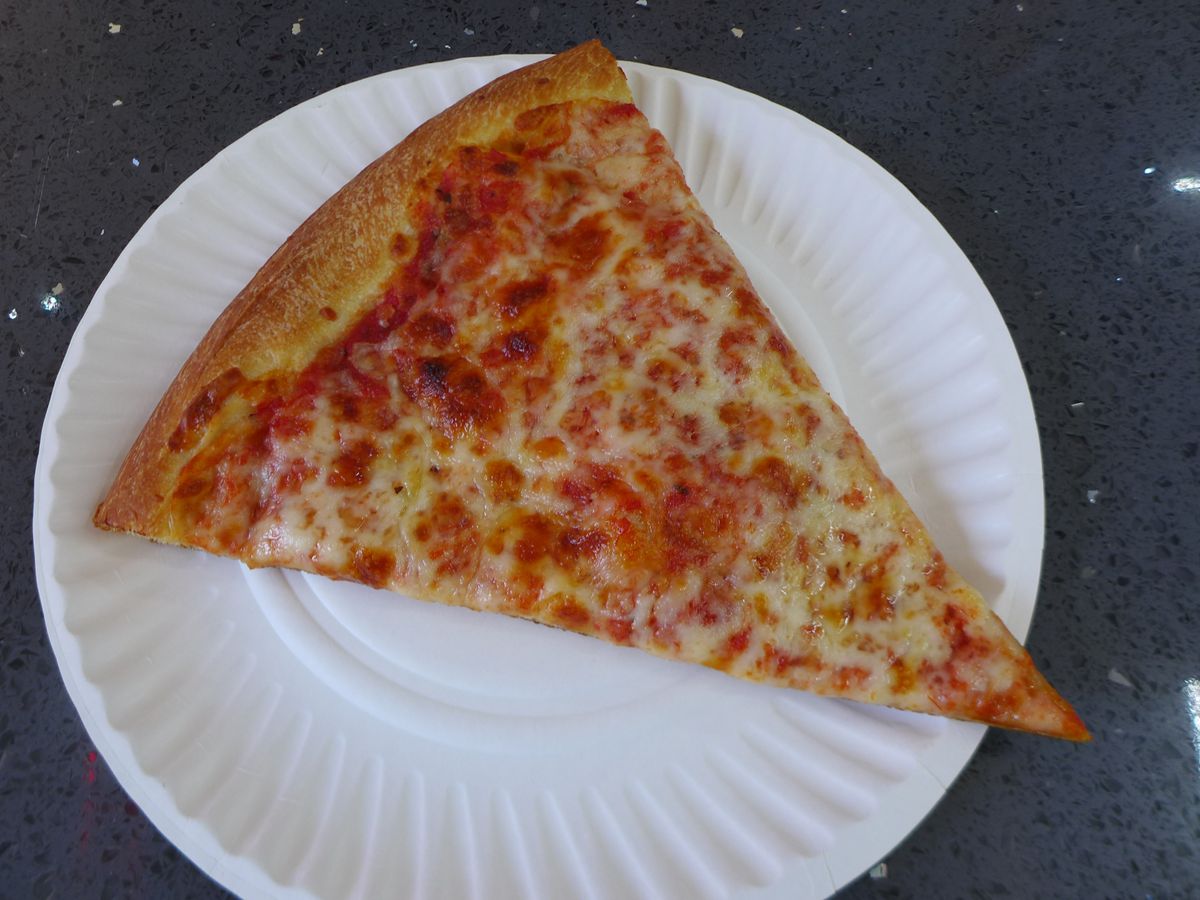 A slice of pizza on a white paper plate.