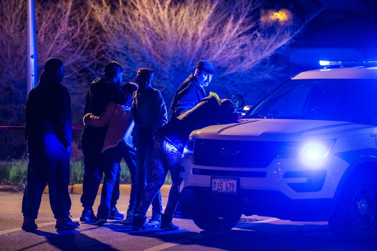 A woman cries atop of a police vehicle after finding out their loved one was killed, Sunday night, in the 4400 block of South Wells, in the Fuller Park neighborhood. | Tyler LaRiviere/Sun-Times