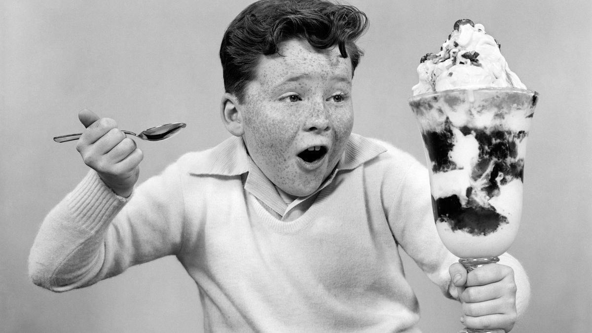A boy marvels at a giant ice cream sundae