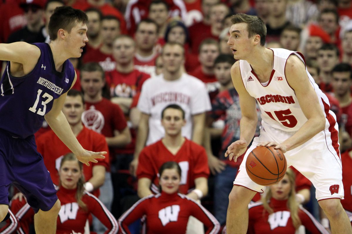 Wisconsin Badgers forward Sam Dekker (15) looks to pass as Northwestern Wildcats forward Kale Abrahamson (13) defends at the Kohl Center. Northwestern defeated Wisconsin 65-56. 