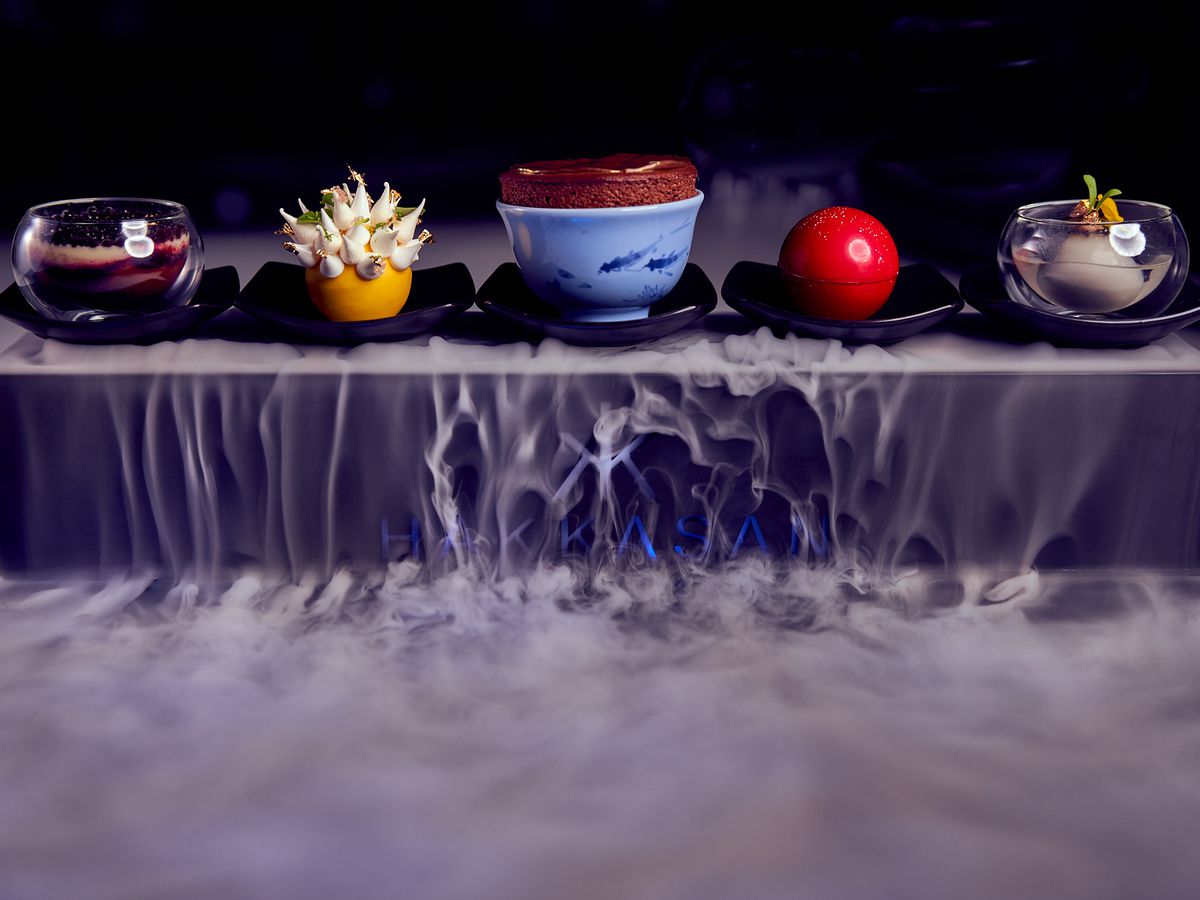 A platter of five desserts on dry ice
