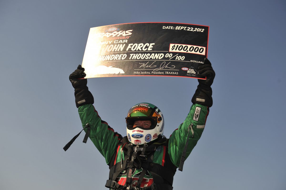 National Hot Rod icon John Force celebrates his $100,000 victory Saturday at the Traxxas Nitro Shootout bonus race for Funny Cars during the AAA Texas Fall Nationals at the Texas Motorplex, south of  Dallas, at Ennis. (Photo courtesy of the NHRA)