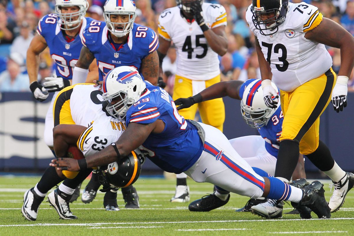 Aug. 25, 2012; Orchard Park, NY, USA;  Buffalo Bills defensive tackle Marcell Dareus (99) tackles Pittsburgh Steelers running back Isaac Redman (33) during the first half at Ralph Wilson Stadium.  Mandatory Credit: Timothy T. Ludwig-US PRESSWIRE