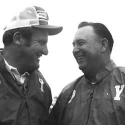 BYU head football coach LaVell Edwards talks with golfer Billy Casper in 1976.