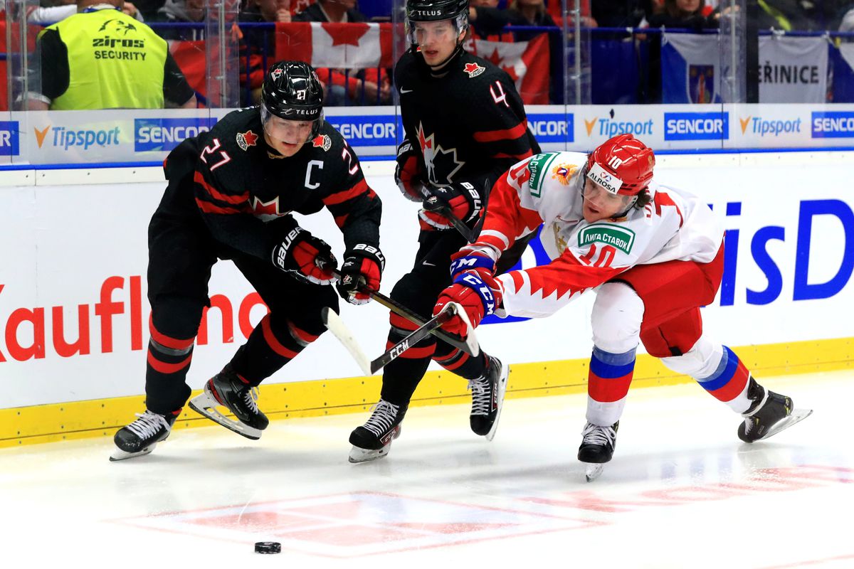 Canada’s Barrett Hayton, Bowen Byram, and Russia’s Dmitry Voronkov (L-R) in the 2020 World Junior Ice Hockey Championship final match between Canada and Russia at Ostravar Arena.
