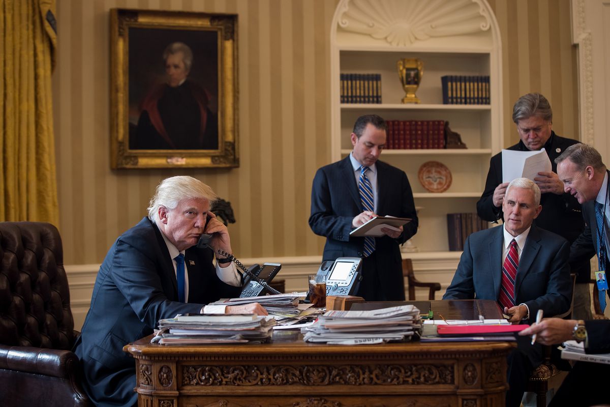 President Donald Trump speaks on the phone with Russian President Vladimir Putin in the Oval Office of the White House, January 28, 2017, in Washington, DC.