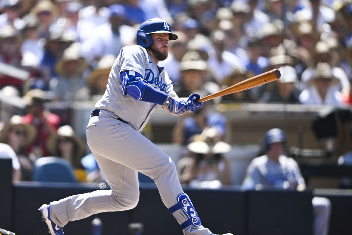 Max Muncy #13 of the Los Angeles Dodgers hits an RBI double during the sixth inning of a baseball game against the San Diego Padres on August 7, 2023 at Petco Park in San Diego, California.