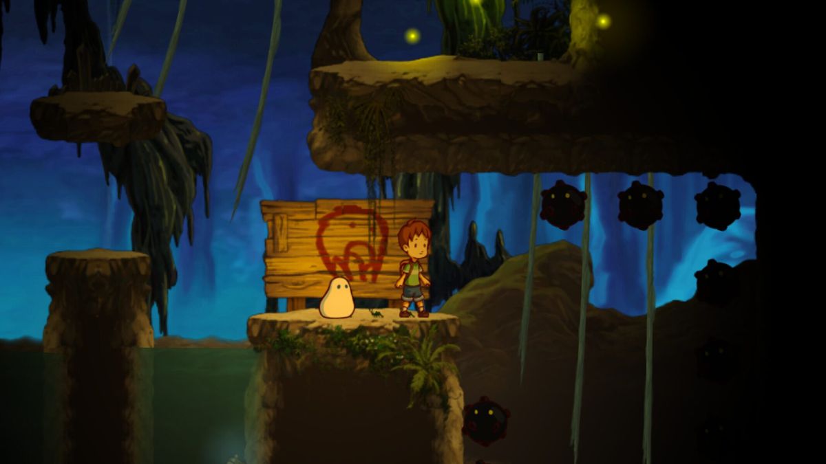 In this screenshot of A Boy And His Blob (2009), the two titular characters stand on a platform together, ready to explore.