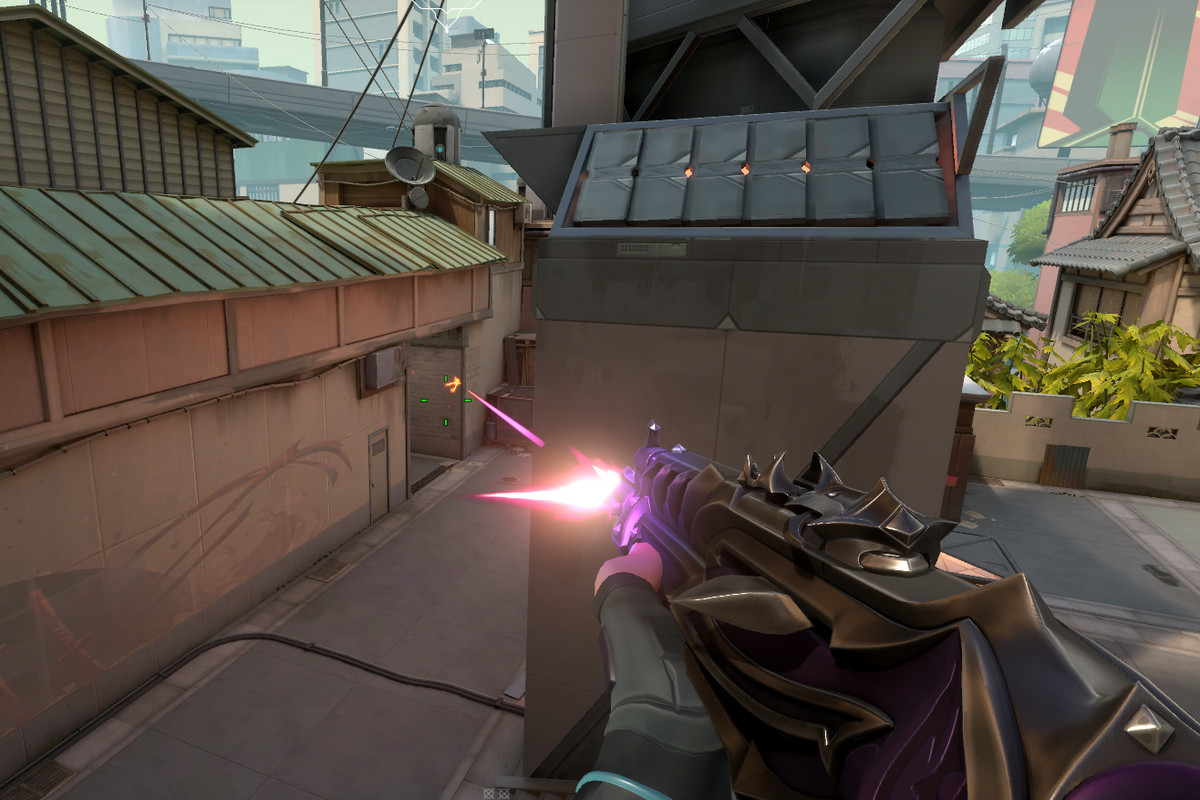 A Valorant player shooting a Vandal with a purple skin on it 