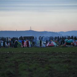 Migrants wait in line for hot soup rations at the northern Greek border station of Idomeni, Tuesday, March 8, 2016. Up to 14,000 people are stranded on the outskirts of the village of Idomeni, with more than 36,000 in total across Greece, as EU leaders who held a summit with Turkey on Monday said they hoped they had reached the outlines of a possible deal with Ankara to return thousands of migrants to Turkey. 