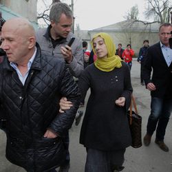 Zubeidat Tsarnaeva, mother of Tamerlan and Dzhokhar Tsarnaev, the two men accused of setting off bombs near the Boston Marathon finish line on April 15, 2013 in Boston, is besieged by reporters as she walks with an unidentified man near her home in Makhachkala, Dagestan, southern Russia, Tuesday, April 23, 2013. The Tsarnaev brothers are accused of setting off the two bombs at the Boston Marathon on April 15 that killed three people and wounded more than 200. Tsarnaev, 26, was killed in a gun battle with police. His 19-year-old brother, Dzhokhar Tsarnaev, was later captured alive, but badly wounded.  (AP Photo/Ilkham Katsuyev)