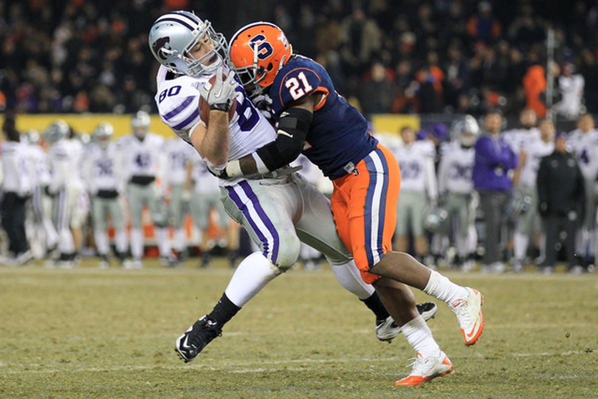 Travis Tannahill (80) of the Kansas State Wildcats is tackled by Thomas Shamarko (21) of the Syracuse Orange during the New Era Pinstripe Bowl at Yankee Stadium on December 30 2010 in New York New York.  (Photo by Chris McGrath/Getty Images)