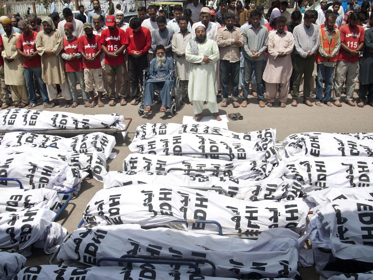 In this Friday, June 26, 2015 file photo, mourners attend a funeral for unclaimed people who died of extreme weather, in Karachi, Pakistan, after a devastating heat wave that struck southern Pakistan the previous weekend, with over 800 confirmed deaths according to a senior health official.