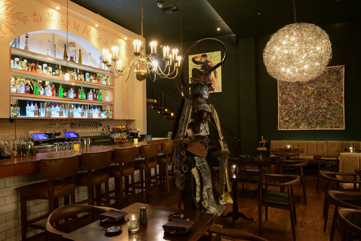 A bar and dining area with a samurai statue at Leona’s Sushi House in Studio City, California.