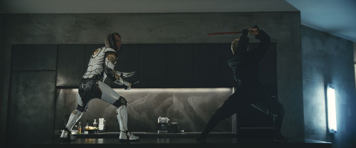 The Hero (Walton Goggins) fights someone dressed like a ninja with a sword in a still from I’m a Virgo